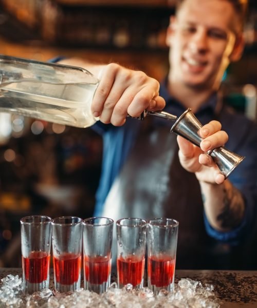 male-barman-in-apron-prepares-alcoholic-coctail.jpg